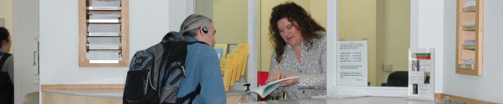 Woman showing a man a book