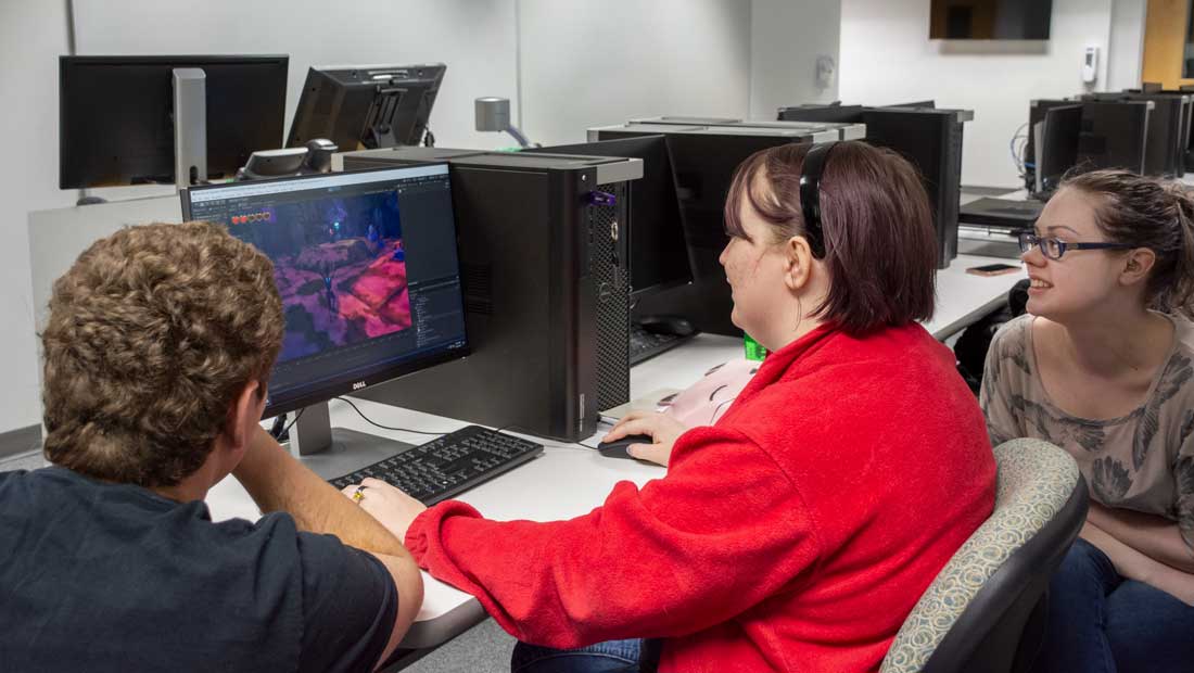 Three students sitting at a computer