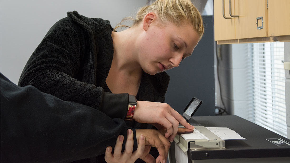 Woman fingerprinting someone