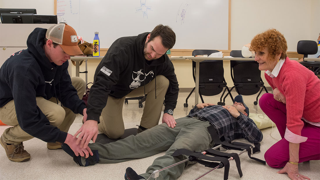 Students working on a patient