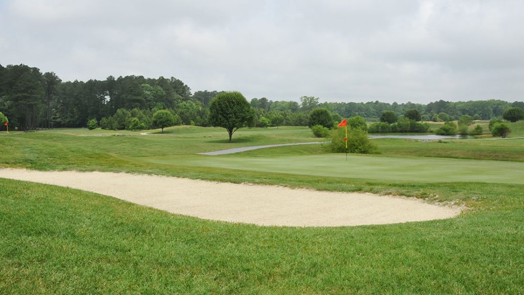 Golf course with a red flag at the hole
