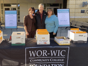 three people behind registration table