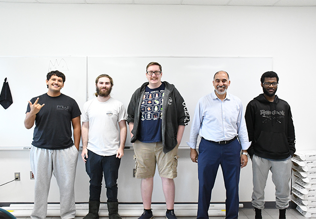four students with their professor