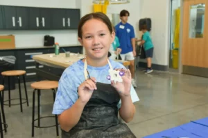 child holding art project