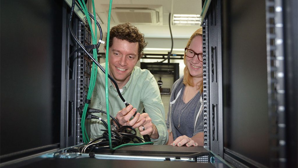 Students working on insides of computer