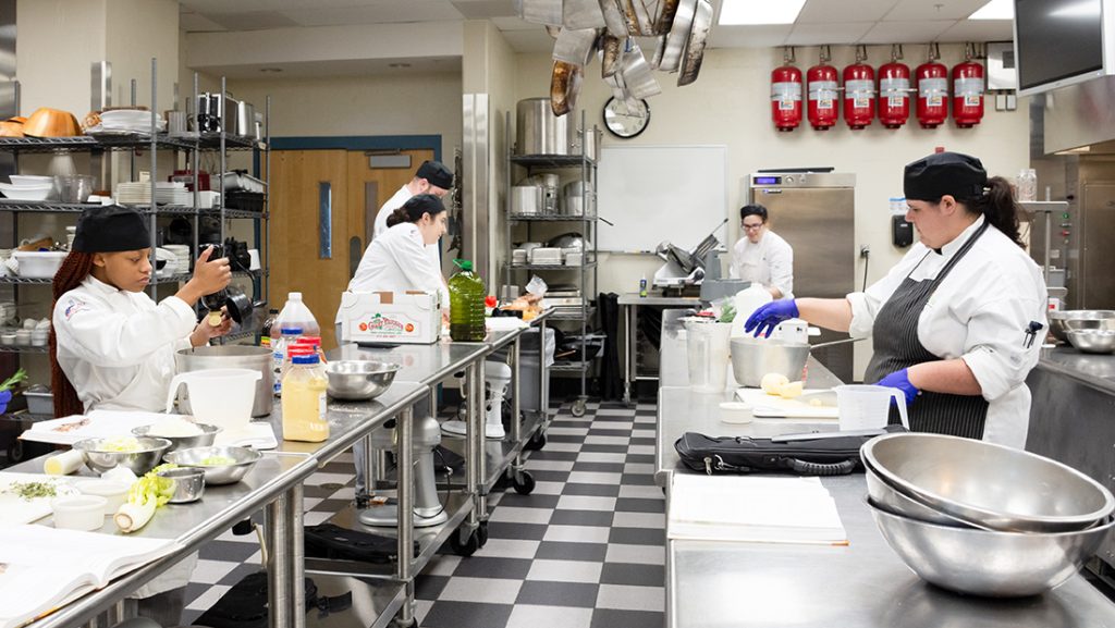 Students in a kitchen cooking