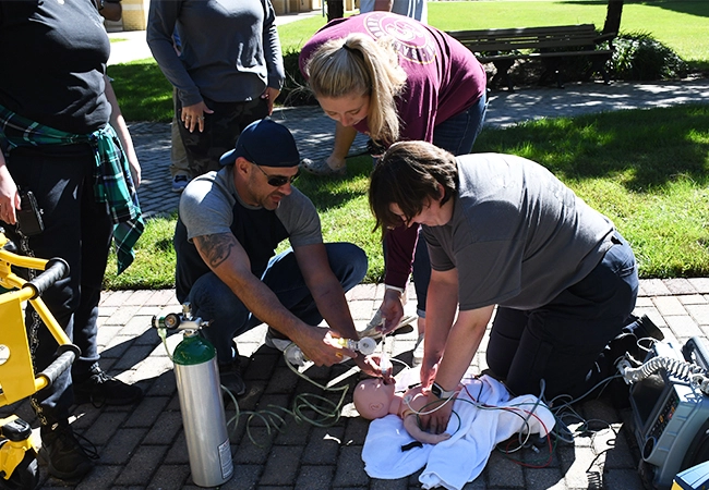 ems students working on baby mannequin